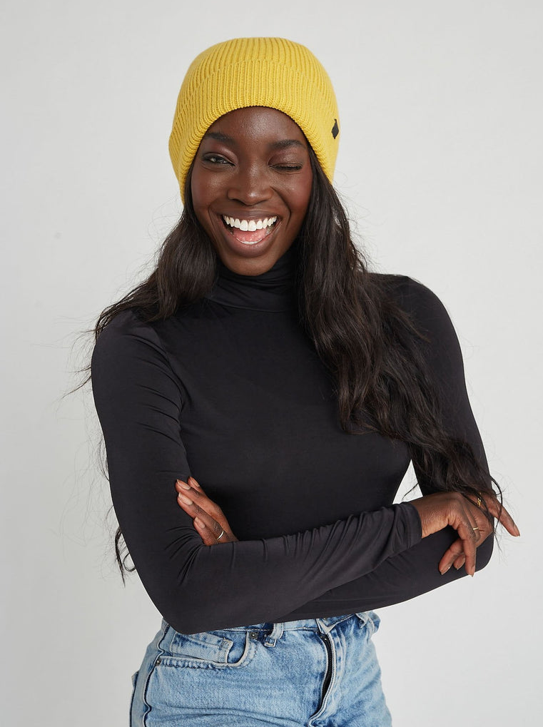 model in mustard yellow beanie