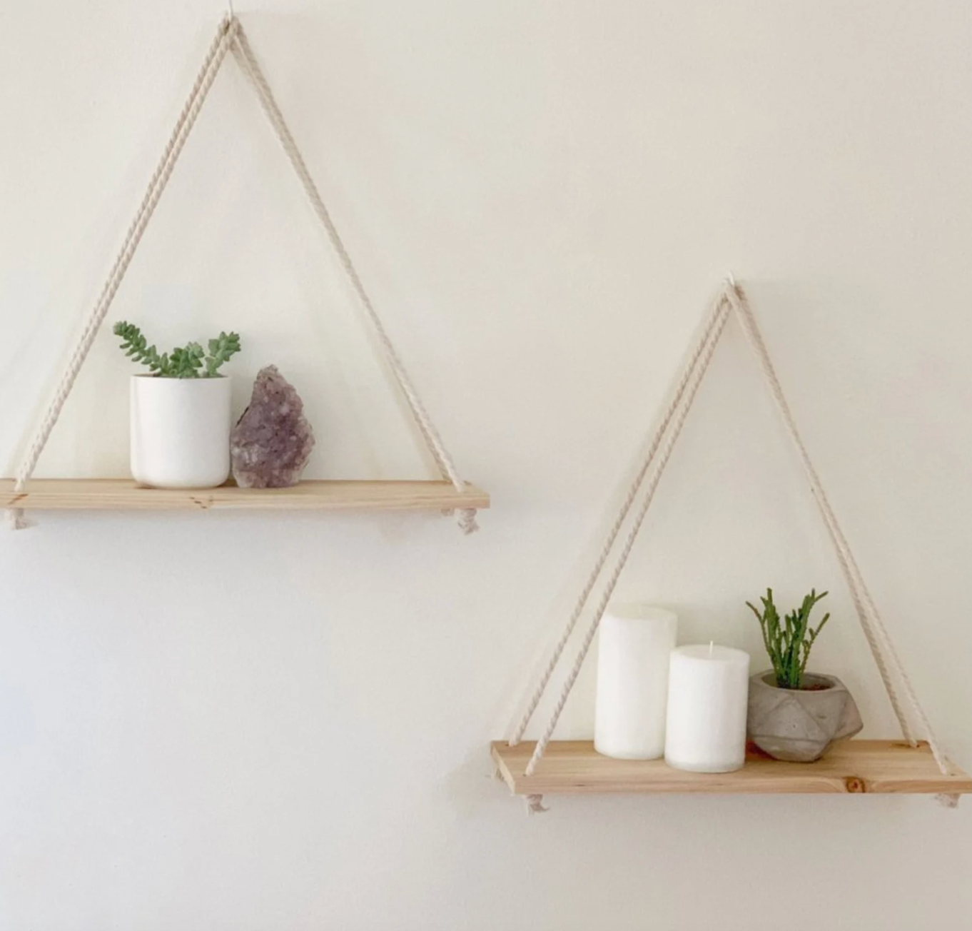 two floating shelves holding candles and plants