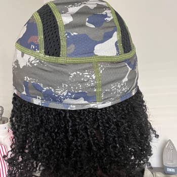 Person wearing vented cooling headdress and displaying the back