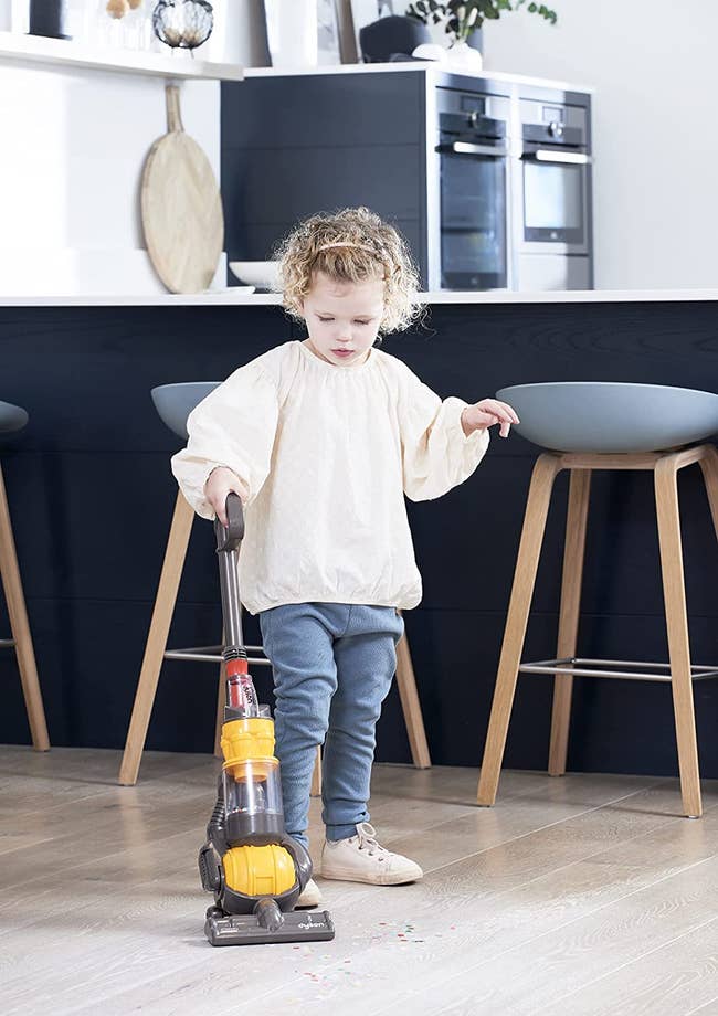child playing with realistic looking mini dyson ball toy