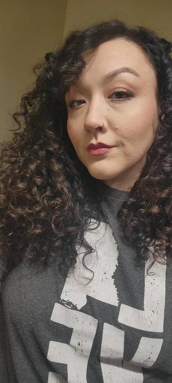 A reviewer with curly, healthy-looking hair after using the product