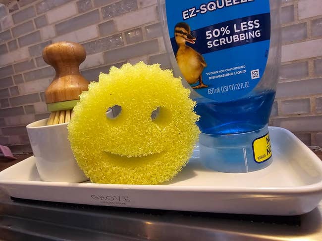 a yellow scrub daddy smiley face sponge
