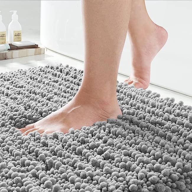 Model stepping into the plush material of the rug