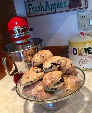 the red kitchenaid next to a plate of scones
