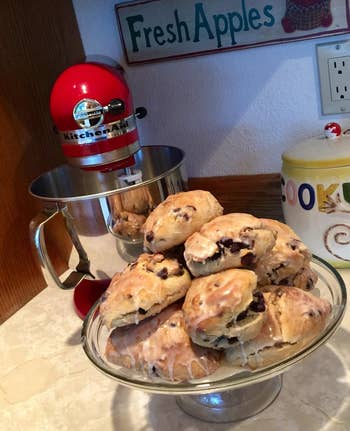 the red kitchenaid next to a plate of scones