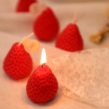 red version of candles with one of them lit 
