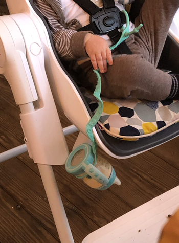 cup catcher holding baby bottle from hitting the floor