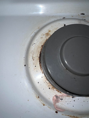 reviewer before photo of dirty gas stove top