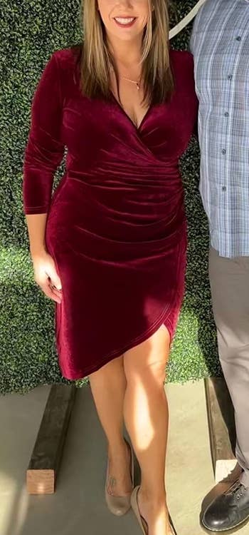 a reviewer wearing the dress in wine red