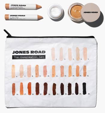 Makeup acceptable with a assortment of instauration shades, cosmetic pencils, a tiny jar, and a marked cosmetic container labeled