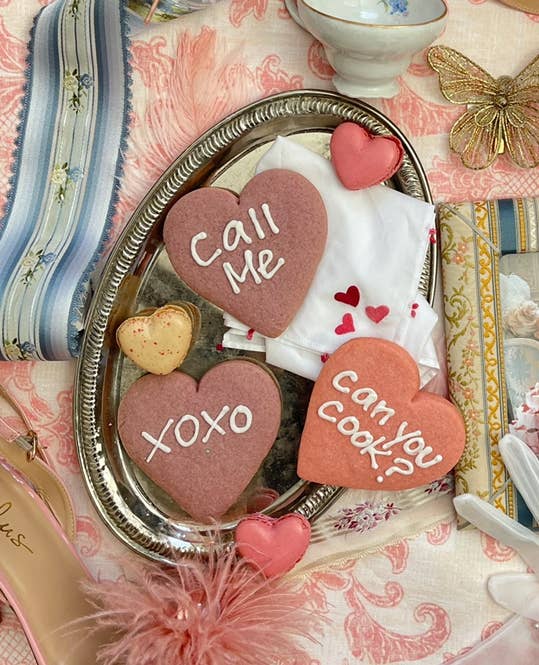 heart-shaped cookies with fun sayings on them