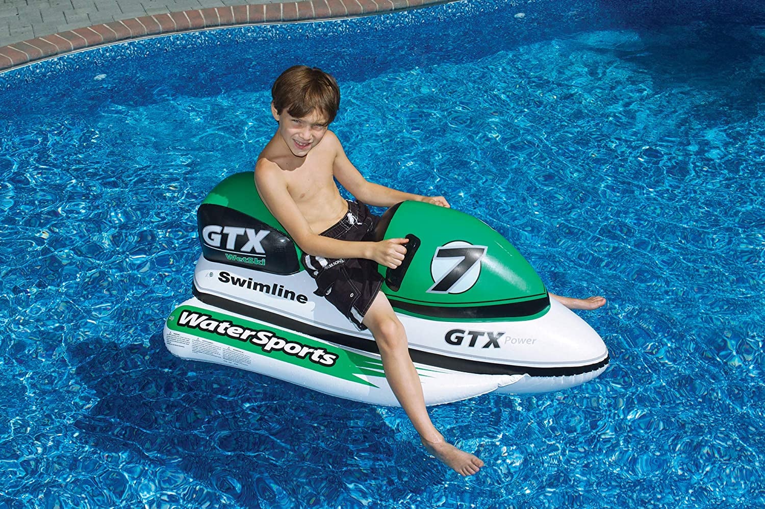 kid on black, green, and white jet ski float with handles