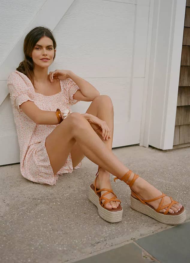 model wearing platform sandals with wrap-up style and criss-cross straps