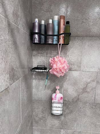 Shower country with products similar shampoo, assemblage wash, a pinkish loofa connected sleek partition racks