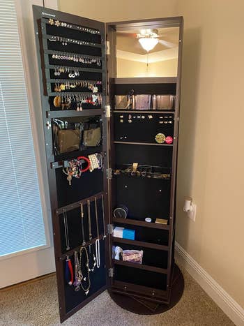same reviewer's cabinet open revealing all the jewelry it holds