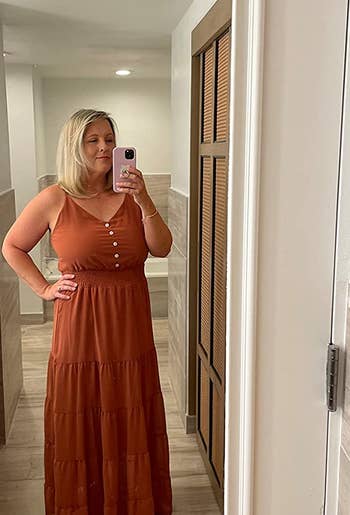 a reviewer wearing the dress in rust orange 