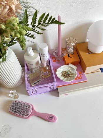 A reviewer using the pink crate for beauty products