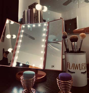 reviewers tri-fold mirror with LED lights lit up