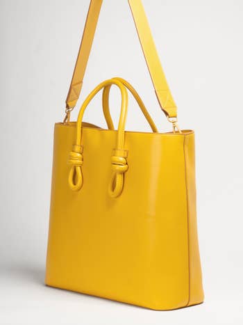 yellow tote with knotted handles and long strap