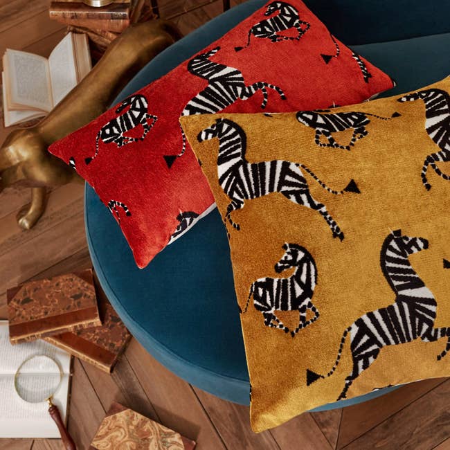 two pillows with zebra pattern on velvet material