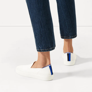 white sneakers with blue stripes on the heels
