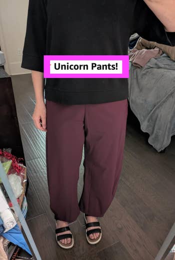 Person wearing relaxed-fit pants and sandals successful  a bedroom. Image labeled 