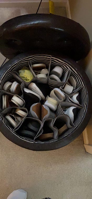 A look inside a reviewer's ottoman showing their shoes stored neatly in it
