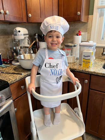Child in white chef outfit with 