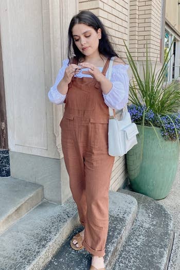reviewer wearing the brown overall