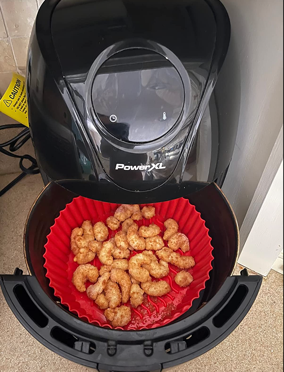 A red liner in an air fryer full of nuggets 