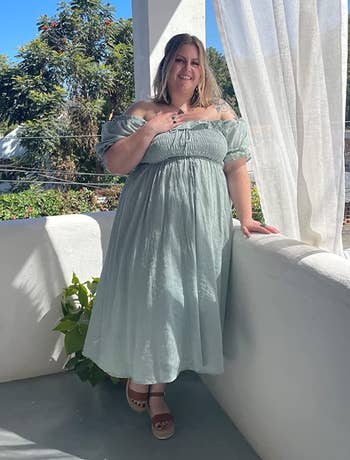 Reviewer in sage green peasant-inspired dress outdoors