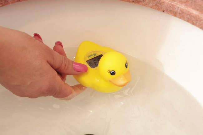 a rubber duck thermometer in a tub