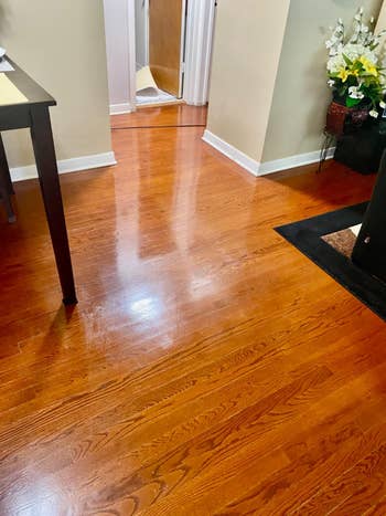 Polished hardwood level  successful  a cozy location  interior, starring  to an unfastened  doorway. A array  and decorative flowers are partially visible