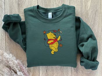 green sweatshirt with winnie the pooh