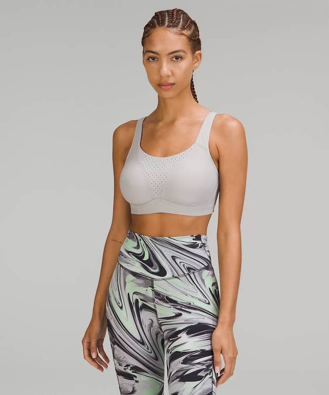 model wearing the gray bra with gray, black, and green leggings