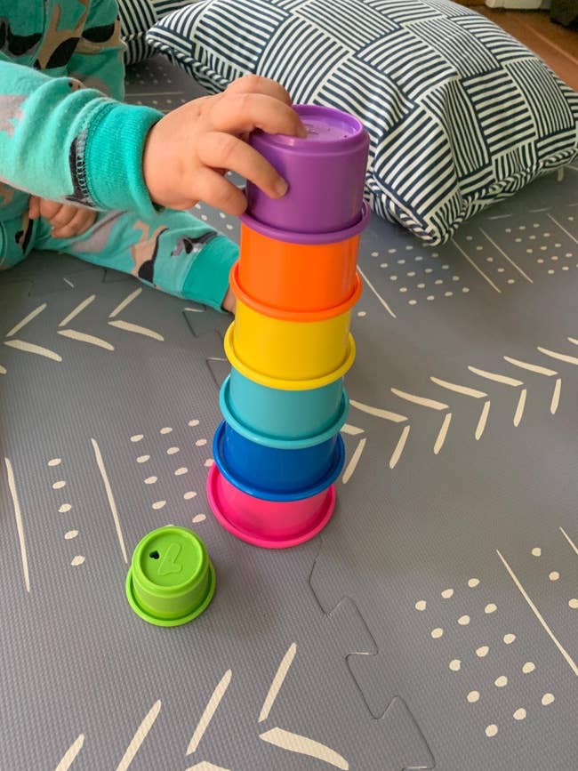 reviewer's child playing with stacking cups