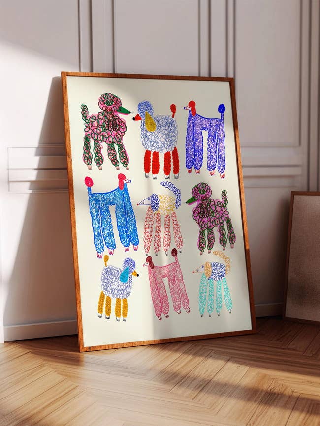 Art people     featuring colorful, abstract poodle illustrations displayed successful  a woody  frame, leaning against a partition  successful  a modern, minimalist interior