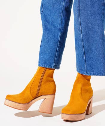 model wearing the yellow boots with jeans