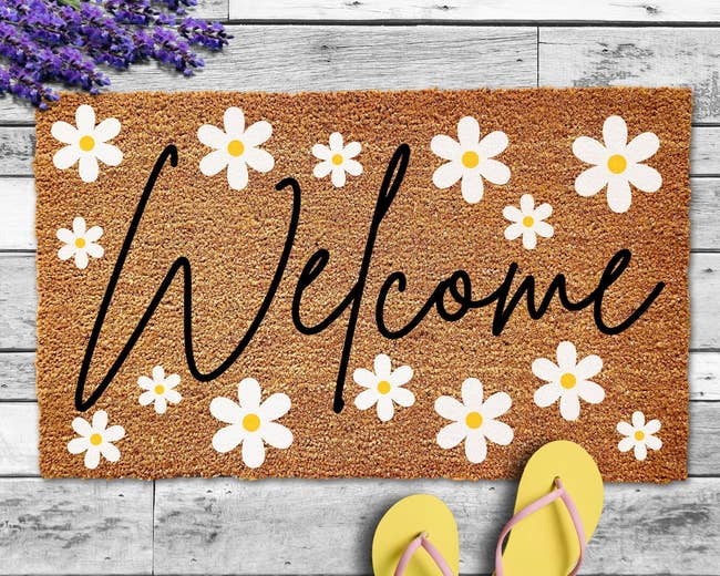 Welcome mat with daisies painted on