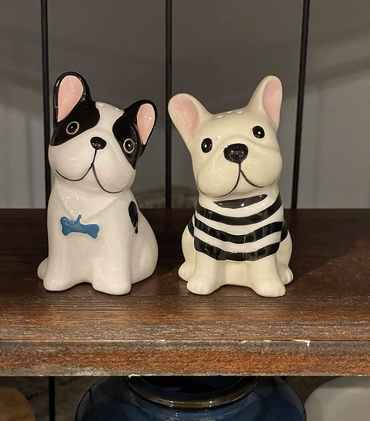 salt and pepper shaker set shaped like two frenchies, one black and white and one blonde in a striped shirt