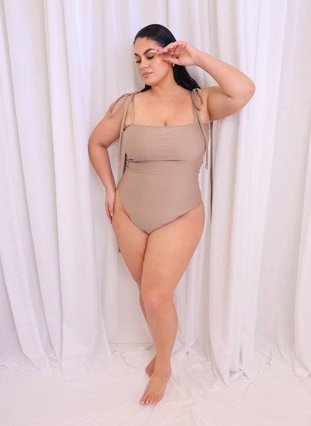 model posing in beige swimsuit 
