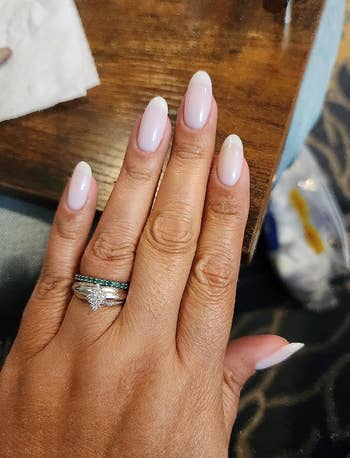 reviewer wearing milky white nail polish