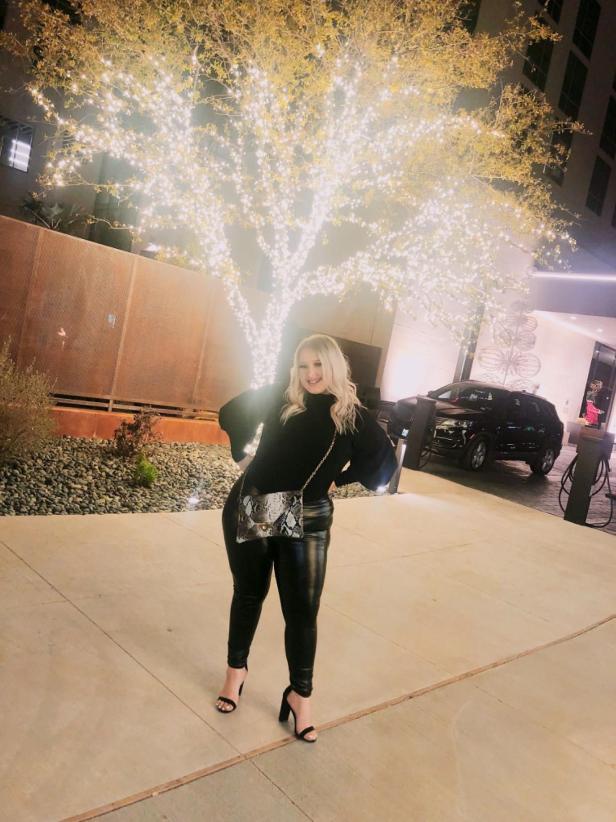 a reviewer wearing the leggings with a formal top and heels