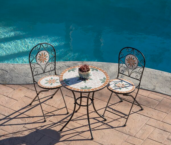 a round mosaic bistro table with two matching chairs next to a pool