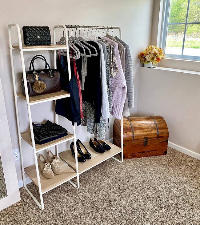 reviewer's white garment rack with four shelves