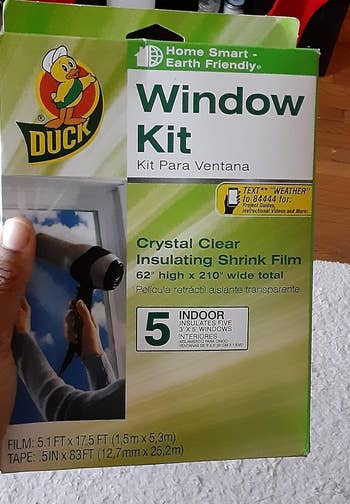 reviewer holding the window insulation kit