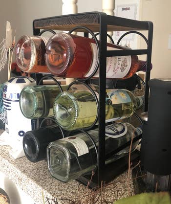 Reviewer image of the black wine rack with bottles 