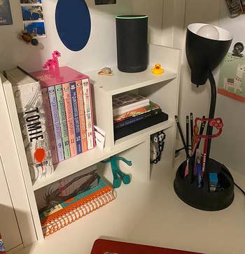 the white adjustable shelves in a desk setup