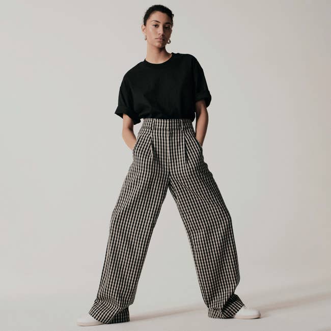 model wearing the wide-leg checkered pants in black and beige