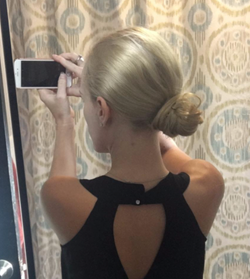 same reviewer with hair in a bun using a pin 